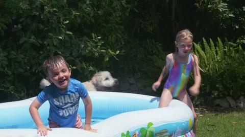 Kids playing in an inflatable pool Stock Footage 112945063