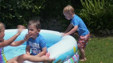 Kids playing in an inflatable pool Stock Footage 112946114