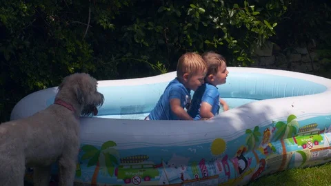 Kids playing in an inflatable pool Video stock 112947844