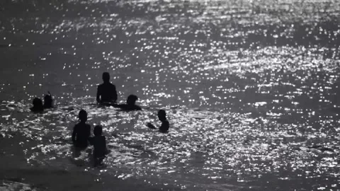 Kids playing in ocean Stock Footage 260578350