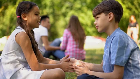 Kids playing pat-a-cake while waiting on a older sister Stock Footage 127800172