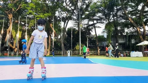 Kids playing roller skates in an open field Stock Footage 220168944