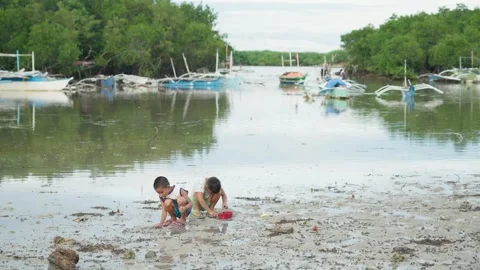 Kids playing with sand at beach in Philippines Stock Footage 325420675