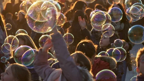 Kids playing soap bubbles in sunset lights at Terrazza del Pincio, Rome, Italy Stock Footage 101463033