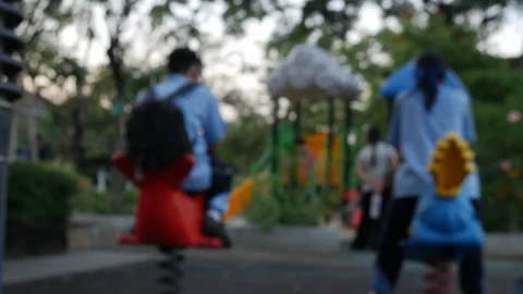 Kids Playing Spring Riders Outdoor Park Bokeh Background Stock Footage 325695053