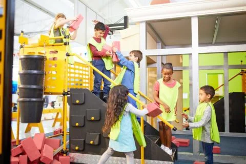 Kids playing, stacking bricks at interactive construction exhibit in science 写真素材