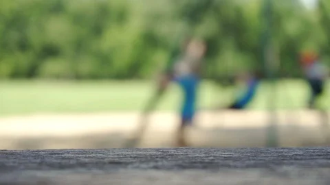 Kids playing on a swing set out of focus, in slow motion Stock Footage 87269334