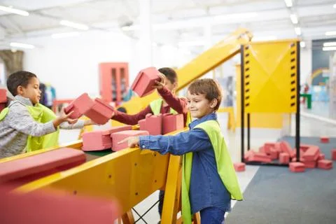 Kids playing with toy bricks at interactive construction exhibit in science Stock Photos