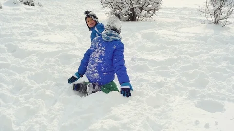 Kids playingon the snow Stock Footage 87084390