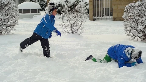 Kids playingon the snow Stock Footage 87084584
