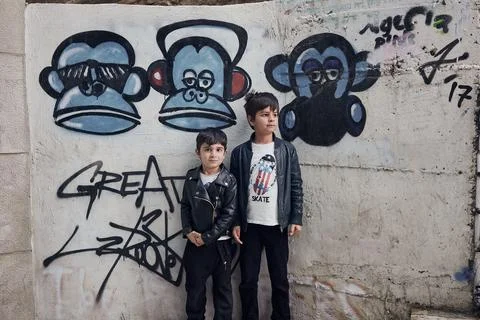 Kids posing with graffiti in the background 写真素材