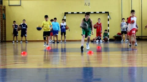 Kids practicing basketball Stock Footage 68043656
