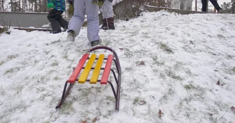 Kids Pull a Sledge Uphill Winter Activities Children Are Playing Toether Stock Footage 59016161