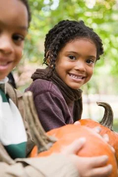 Kids with pumpkins Stock Photos