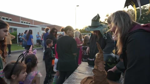 Kids Queue for Candy at Sunset Halloween Festival Stock Footage 318105327