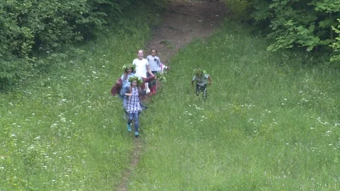 Kids run down hill in midsummer day holiday Stock Footage 104865008