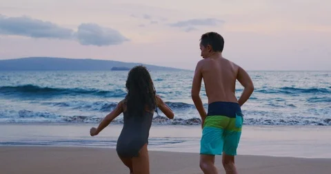 Kids Running into The Ocean Stock Footage 92644302