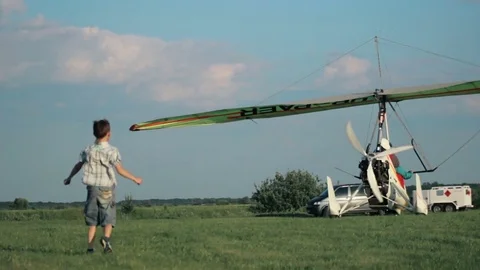Kids running for the plane which takeoff the land Stock Footage 73783736