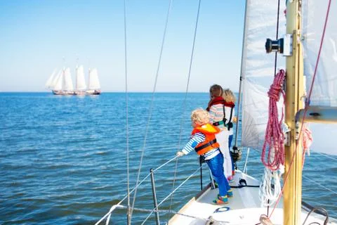 Kids sail on yacht in sea. Child sailing on boat. Stock Photos