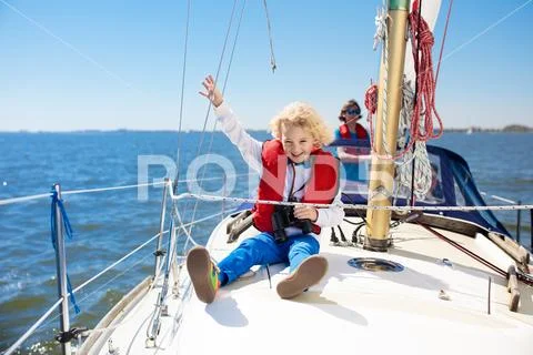 Kids sail on yacht in sea. Child sailing on boat. Stock Photos
