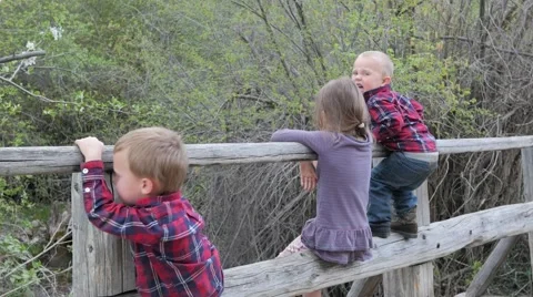 Kids sitting on bridge Video stock 49685367