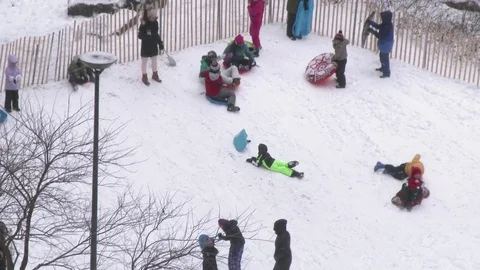 Kids sledding in park during snowfall aerial view 스톡 동영상 72672902