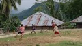 Kids in small indonesia mountain village playing football soccer on dirty field 4k or 4k+ Resolution