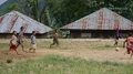 Kids in small indonesia mountain village playing football soccer on dirty field 4k or 4k+ Resolution