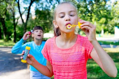 Kids with soap bubbles Stock Photos