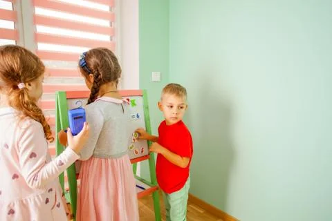 Kids solve the mathematical problem on the board Stock Photos