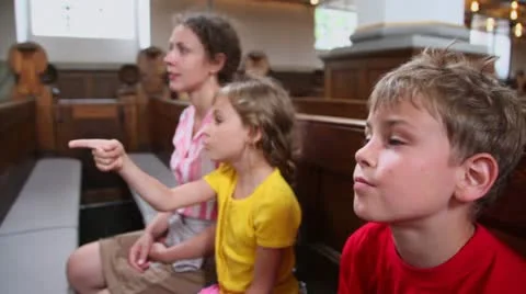 Kids speak with mother about religion when they sit in church Stock Footage