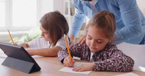 Kids studying online class on tablet during remote lesson drawing with pencil. Stock Footage 315288938