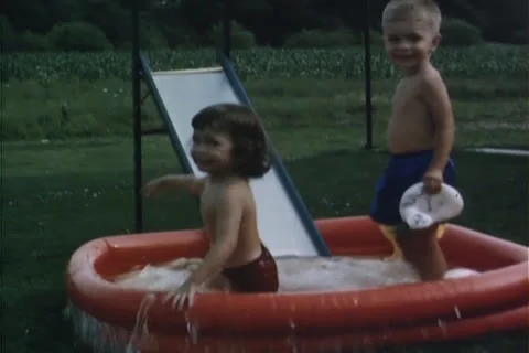Kids Swimming in the backyard pool Stock Footage 24826644