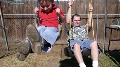 Kids swing with Dad Stock Footage 10722327
