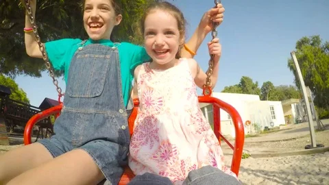 Kids on a swing during summer break - POV footage Video stock 77969147