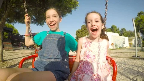 Kids on a swing having fun and laughing Video stock 77969375