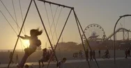 Kids Swing Near Amusement Park At Sunset Stock Footage