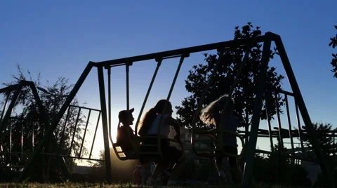 Kids on a swing at sunset time 動画素材 50648192