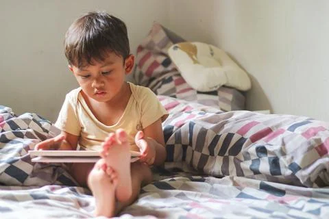Kids with tablet computer. Child with pc watching movie or playing game. Ed.. Stock Photos