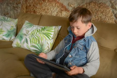 Kids with tablet computer. A mockup of a tablet in the hands of a child. Ed.. Stock Photos