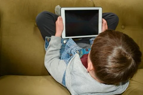 Kids with tablet computer. A mockup of a tablet in the hands of a child. Ed.. Stock Photos