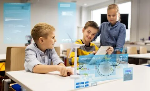 Kids with tablet pc programming at robotics school Stock-Fotos