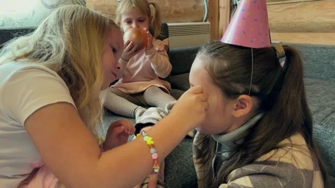 The kids take turns decorating each other's faces Stock Footage 293613370