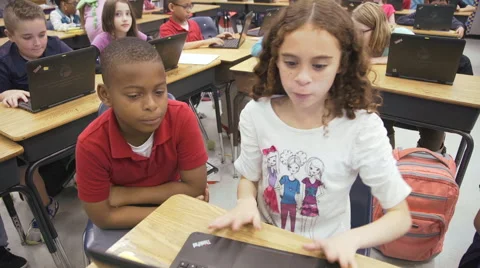 Kids teaching each other, white girl and African American kid Video stock 62655865