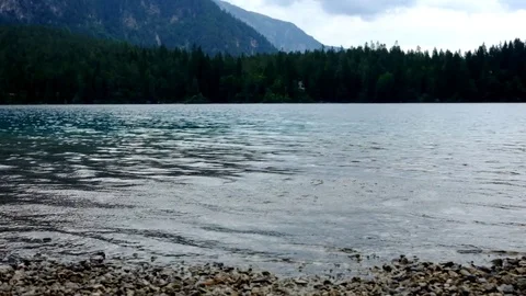 Kids throw a stone in a lake Stock Footage 79566729