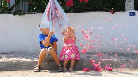Kids with umbrella and flowers Stock Footage