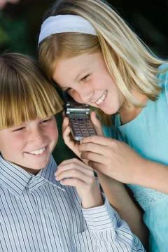 Kids Using Cellphone Together Stock Photos