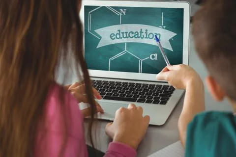 Kids using a computer with school icons on screen 스톡 사진