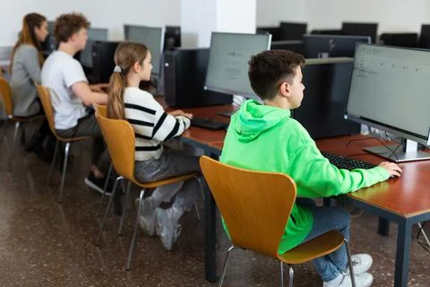 Kids using computers during computer science lesson Stock Photos