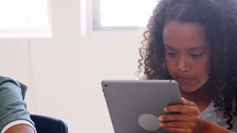 Kids using tablet computers in elementary school, close up Stock Footage